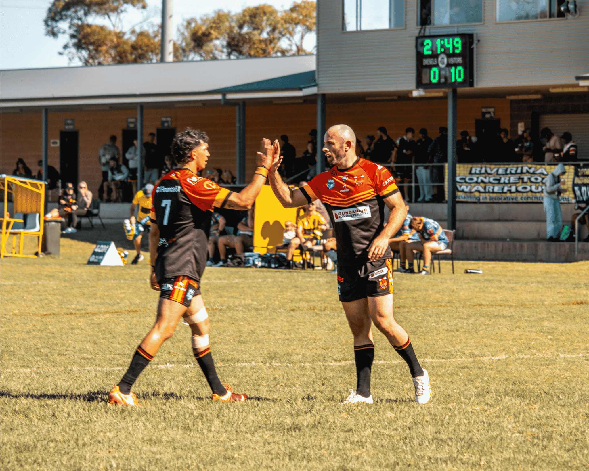 Matt Frawley embracing a team member during a match.