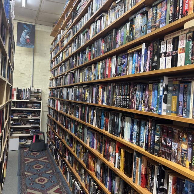 A large bookshelf with a wide range of book covers. 
