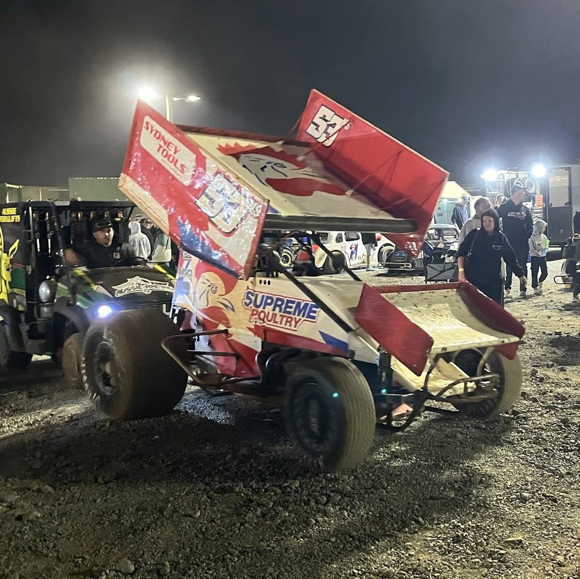 A sprint car with a chicken design titled 'Supreme Poultry'.