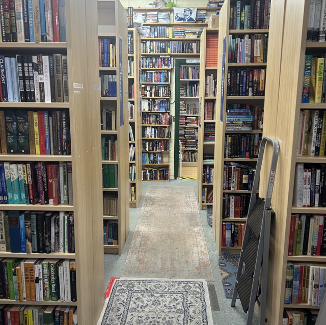 The second room of the bookshop with a look into the third room. It is well stocked. 
