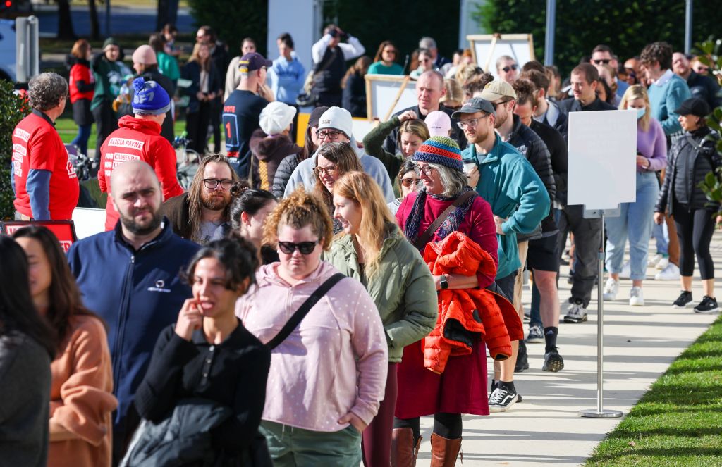 A long line of people lining up outside a polling place in the ACT.