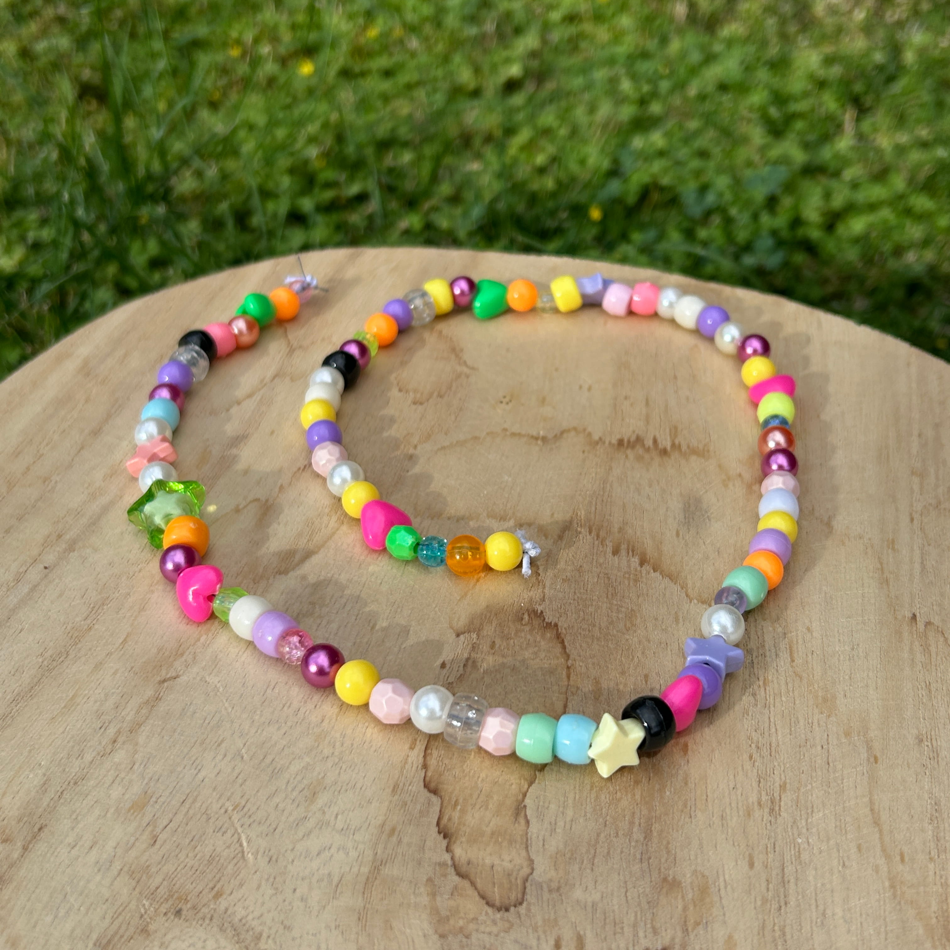 A chain of colourful beads arranged in a circle.