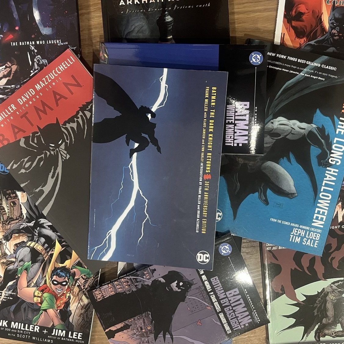 Scattered Batman comics with Dark Knight Returns on top