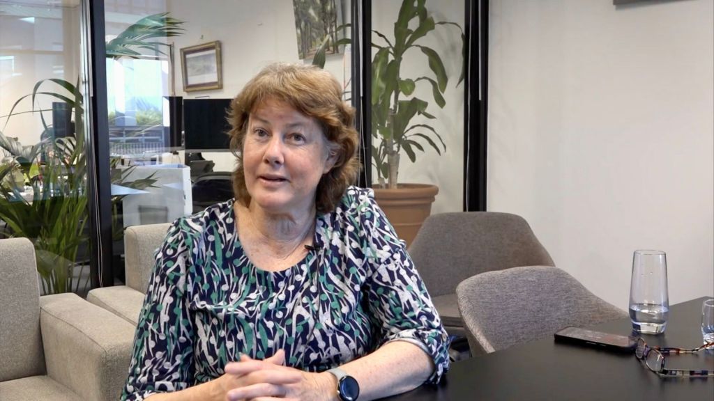 Landscape image of Fiona Carrick sitting in her office.
